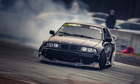 Latvia, Riga 03-05.10.2025. FIA Drifting cup. A black car with a lot of smoke coming out of it. .