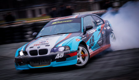Latvia, Riga 03-05.10.2025. FIA Drifting cup. A blue and red car with a lot of smoke coming out of...
