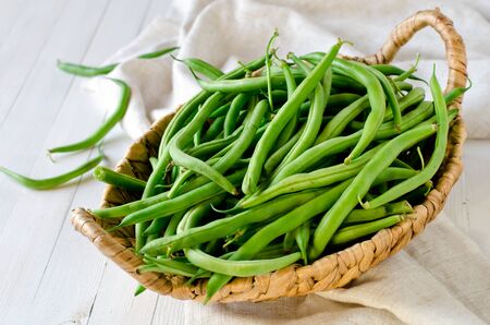 Green beans in a wicker basketの写真素材