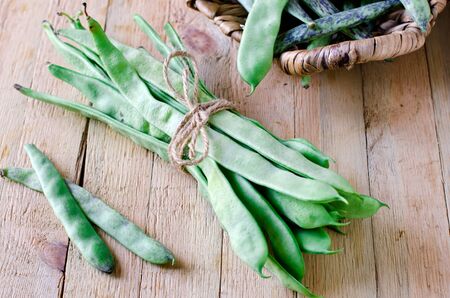Green string beans on a wooden tableの写真素材