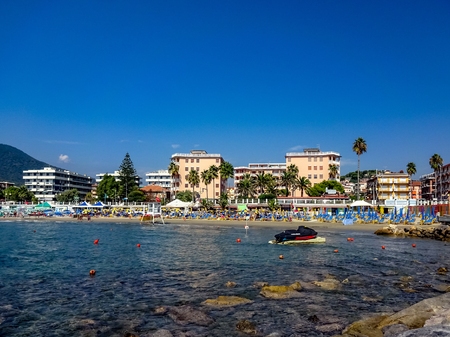 Beach and bay in Andora, Liguria, Italy on a sunny summer day with perfect blue skyesの写真素材