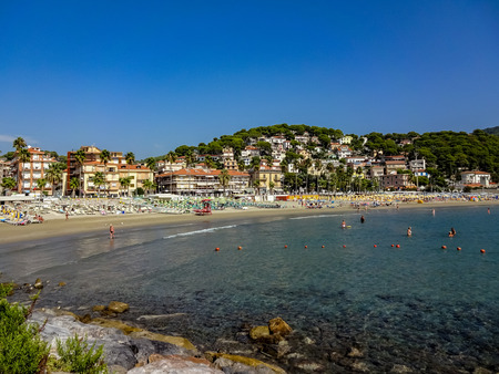Beach and bay in Andora, Liguria, Italy on a sunny summer day with perfect blue skyesの写真素材