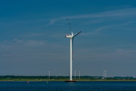 wind power plant at the baltic sea coast on land and in water basedの写真素材