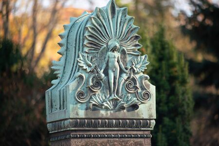 Detailed ancient stone relief of a male angel on a german cemetery in Berlinの写真素材