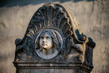Tombstone with the face of a young girl at Dorotheenstadt cemetery in Berlinの写真素材