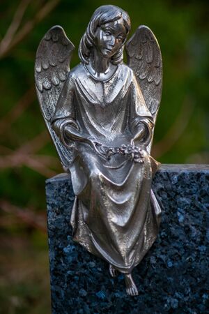 Friedhof Tegel, Berlin, Germany -november 29, 2018: Statue of an angel on a german graveyard on a crisp winter dayの写真素材