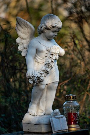 Close up of a statue of an angel on the graveyard Tegeler Fliess, Berlin, Germanyの写真素材