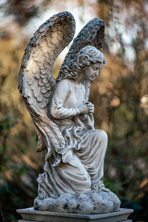 Close up of a statue of an angel on the graveyard Tegeler Fliess, Berlin, Germanyの写真素材