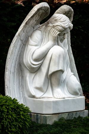 Statue of a mourning angel on a graveyardの写真素材