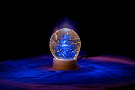 Close up of an Illuminated paperweight with velvet backgroundの写真素材
