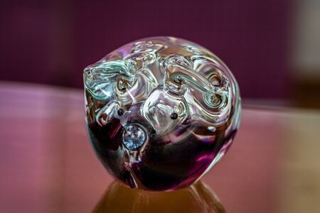 Glassy lucky pig - mouthblown in Scotland with purple glassの写真素材