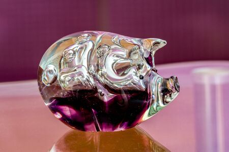 Glassy lucky pig - mouthblown in Scotland with purple glassの写真素材