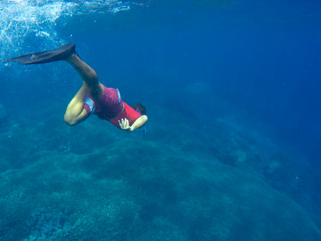 Snorkler man under water in the blue seaの写真素材