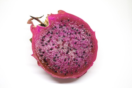 Pitahaya on white background. Isolated dragon fruit with fresh cut. Pink pine with sweet flesh and black seeds. Exotic fruit for dessert or breakfast. Vegetarian food from tropical plant cactusの写真素材