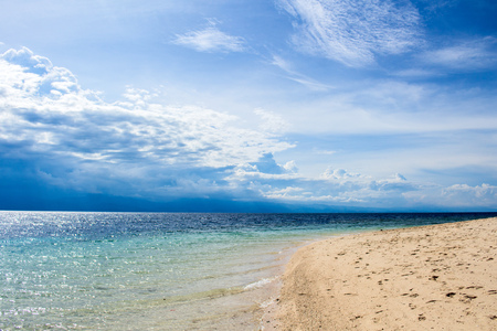 Natural landscape with sea and clouds. Tropical island lagoon in sunny day. Exotic paradise landscape. Sunny white beach view with turquoise seawater. Beautiful seashore. Summer vacation in tropicsの写真素材