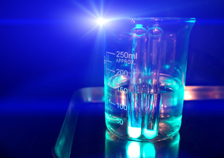 Chemical experiment glass beaker. Glass flask filled with transparent liquid. Clinical analysis. Medical research. chemical experiment concept image. Natural science education. Chemistry lessonの写真素材