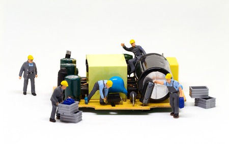 Workers repair computer detail. Miniature worker figurine and micro chip. Men at work macro photo....