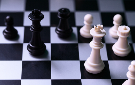 Black and white kings on chess board. Chess figure king. Black and white chess figurine. Stalemate...