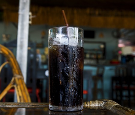 Sparkling drink with ice in glass. Cool beverage in hot summer day.