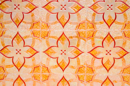 Old ceramic tile background. Bright orange tile paving in arabic style. Oriental floor decor. Simple pattern of street paving. Historic park decoration. Bright yellow ceramic tiles. Eastern backgroundの写真素材