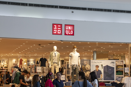 Manila, Philippines 22 March 2018: Uniqlo brand name on store entrance in SM Mall of Asia shopping mall. Modern fashion store label. Casual wear shop. Asian retail company. Men and women clothes brandのeditorial素材