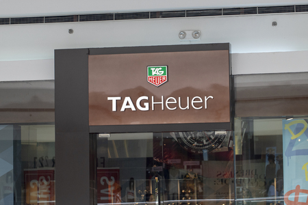 Philippines, 22 March 2018 - Tag Heuer brand name on store entrance in shopping mall. Expensive watch store label. Swiss watches shop. Fashion accessories storefront. Watch shop label closeup photoのeditorial素材