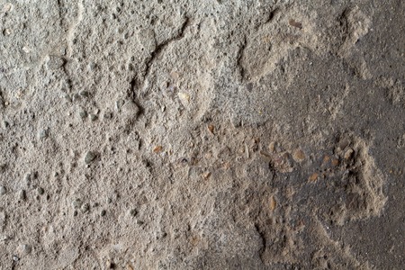 Grunge stone texture photo. Natural stone background. Weathered rock relief. Old building stone wall surface closeup. Distressed stone texture. Solid construction material. Grungy rock formationの写真素材
