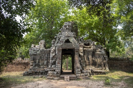 Ancient ruins of Banteay Kdei temple in Angkor Wat complex, Cambodia. Demolished stone tower with...