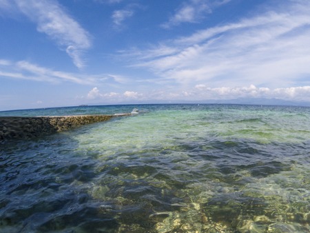 Seaside landscape in fisheye lens, tropical seashore photo. Turquoise blue sea water and blue sky double landscape. Tropical island marine seascape. Romantic view of exotic seaside. Sunny day by seaの写真素材