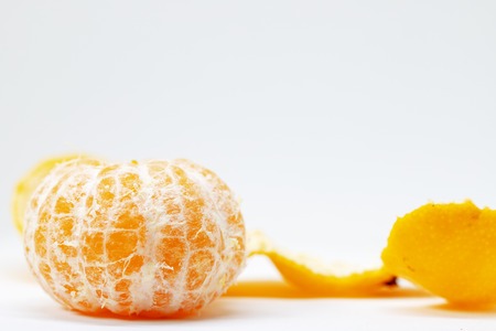 Juicy mandarin closeup on white background. Fresh orange yellow citrus fruit. Whole tangerine...