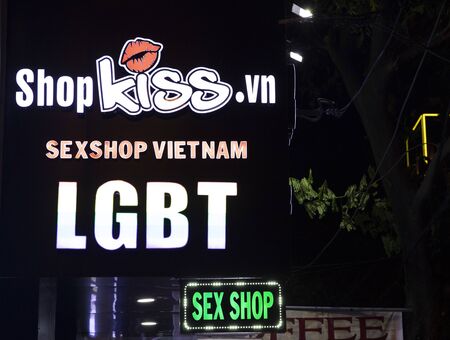 Danang, Vietnam - 26 Jul 2019: Sexshop banner lighting in dark street. Sex shop sign by night. Modern city nightlife. Neon banner on street. Vietnamese LGBT movement in South Asia. Gay friendly shopのeditorial素材