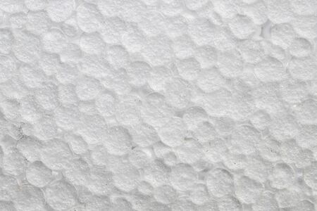 White polystyrene foam surface with closed cells closeup photo. Artificial texture with cell structure. Carbon polymer macrophoto. Abstract backdrop for industrial or hi-tech design. Plastic packageの写真素材