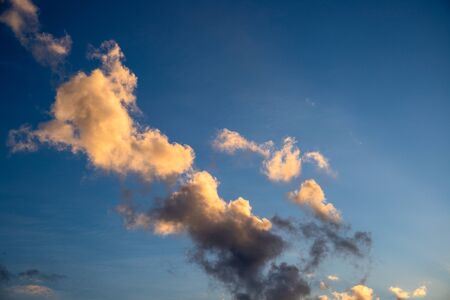 Blue sky with sunny cloud. Sunrise or sunset sky on tropical island. Yellow orange sun light on...