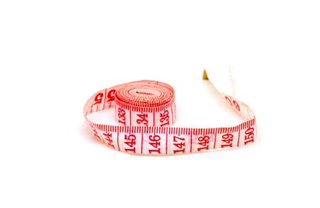 Red tailors centimeter on white background. Measuring tape closeup photo. Tailoring service or...