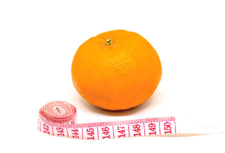 Orange fruit and tailors centimeter on white background. Cellulite fight and slimming diet...