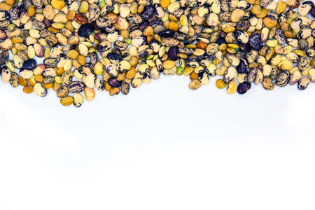 Colorful kidney bean pile with text place on white background. Healthy food banner template with text place. Kidney bean ornament on table. Nutritive dish ingredient photo for cook or recipe bookの写真素材