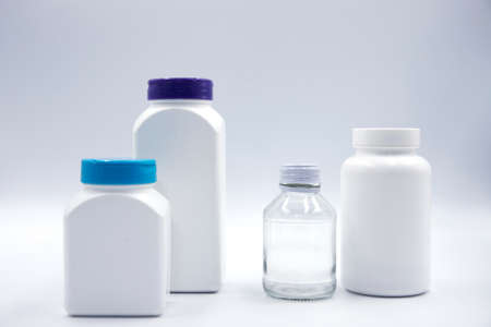 White plastic glass bottle for pill or food supplement studio photo on white background. Pharmacologic container mockup. Pill or drug jar blank package design. Clean pack for medicine diet vitaminの写真素材