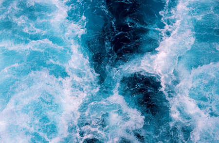 Natural sea foam after motor boat. Seascape perspective view. Maritime transportation on cruise ship or motor boat. White wave on oceanic surface. Deep blue water of open sea . Nautical backgroundの写真素材