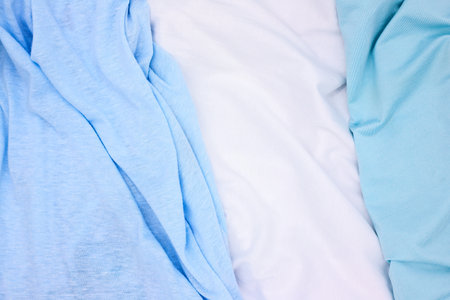 Blue and white fabric top view photo. Gentle colored textile photo texture. Folded fabric with wrinkles for pattern mockup. Blank textile surface. Fashion or retail industry banner templateの写真素材