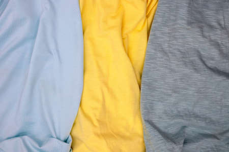 Gray and yellow fabric top view. Colored textile photo texture. Folded fabric with wrinkles for pattern mockup. Blank textile surface. Fashion or retail industry banner templateの写真素材