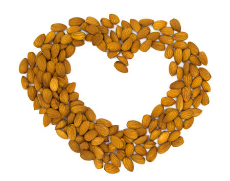 Raw almond heart. Natural organic nut kernel. Protein superfood or healthy snack. Almond pile scattered on white table top view. Golden almond package design. Healthy eating banner templateの写真素材