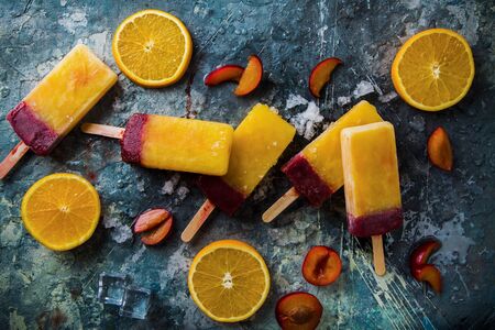 Homemade Orange and Plum ice cream on grey background, Top View with plum and orange pieces. Fruit ice cream of different flavours, concept image, top view.の写真素材