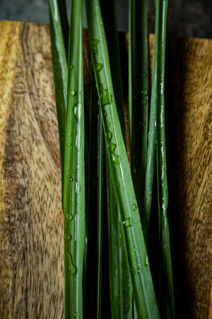 Fresh lemongrass or citronella grass on rustic wooden board. Herb used for healthy eating.の写真素材