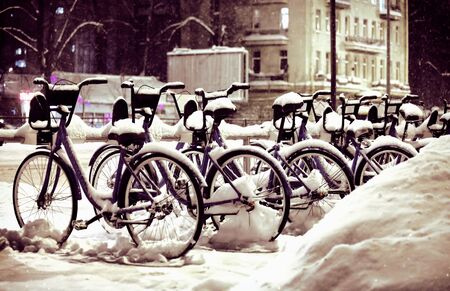 Bicycles in winter in the snow on the road, nightの写真素材