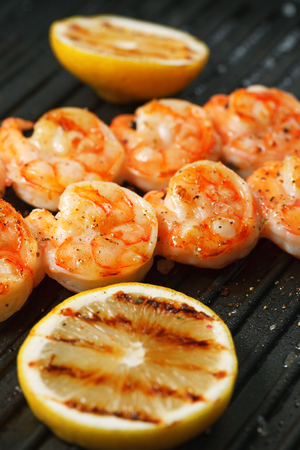 Grilled tiger shrimps with spiced and lemon on the grillの写真素材