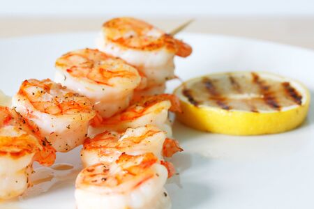 Grilled tiger shrimps with spiced and lemon. White plateの写真素材