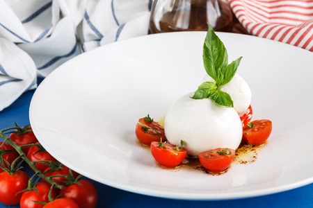 burrata salad with tomato and basil. Close up