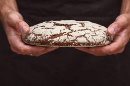 Baker man holding a warm breadの写真素材