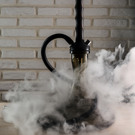 wooden hookah on a white wooden table on brick wall backgroundの写真素材