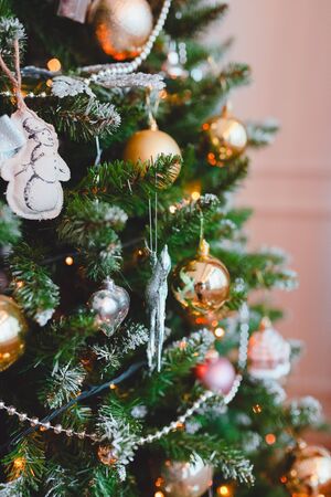 Christmas tree closeup with gold and pink balloons. Pink backgroundの写真素材
